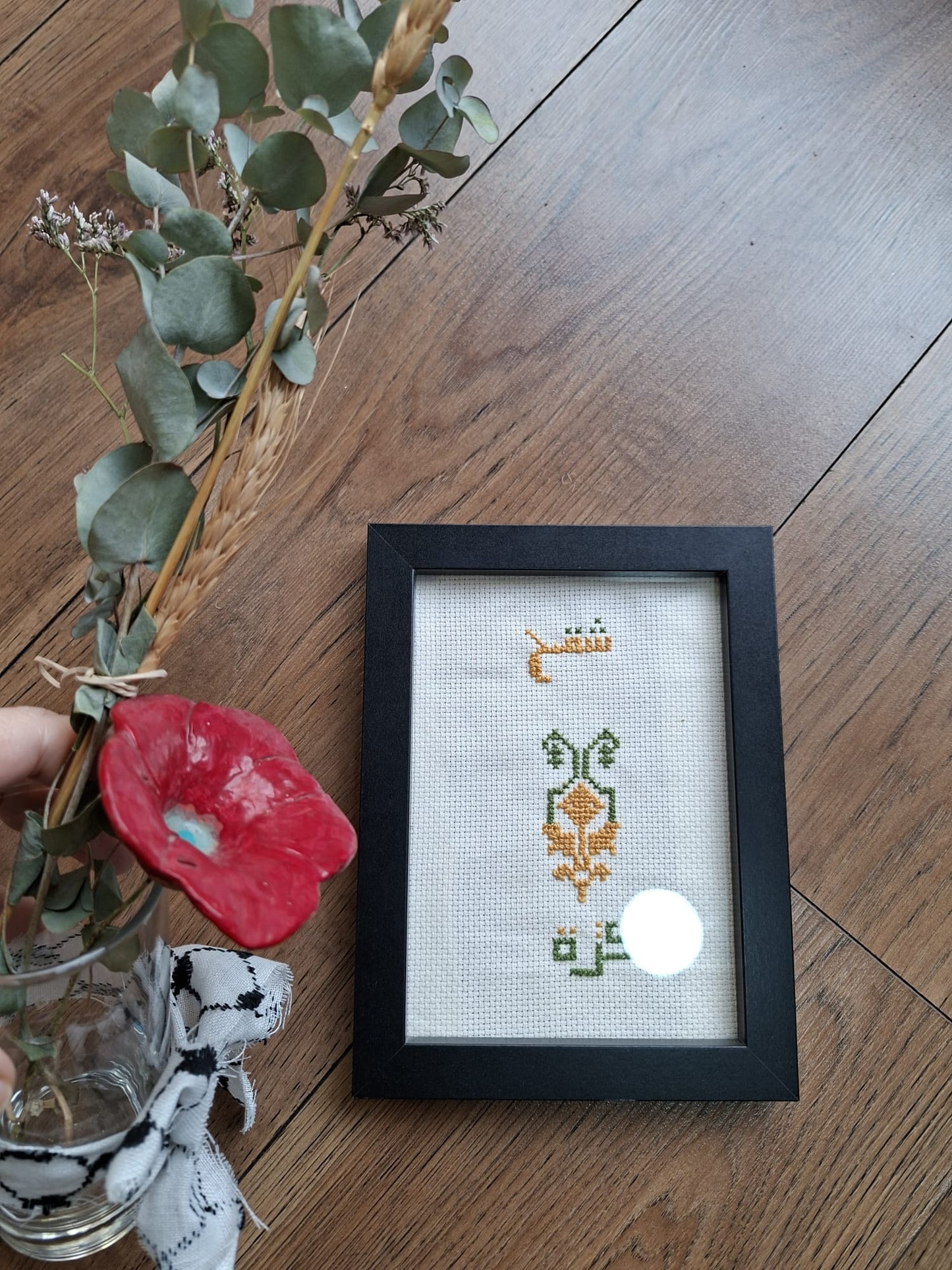 A framed piece of traditional Palestinian *Tatreez* embroidery